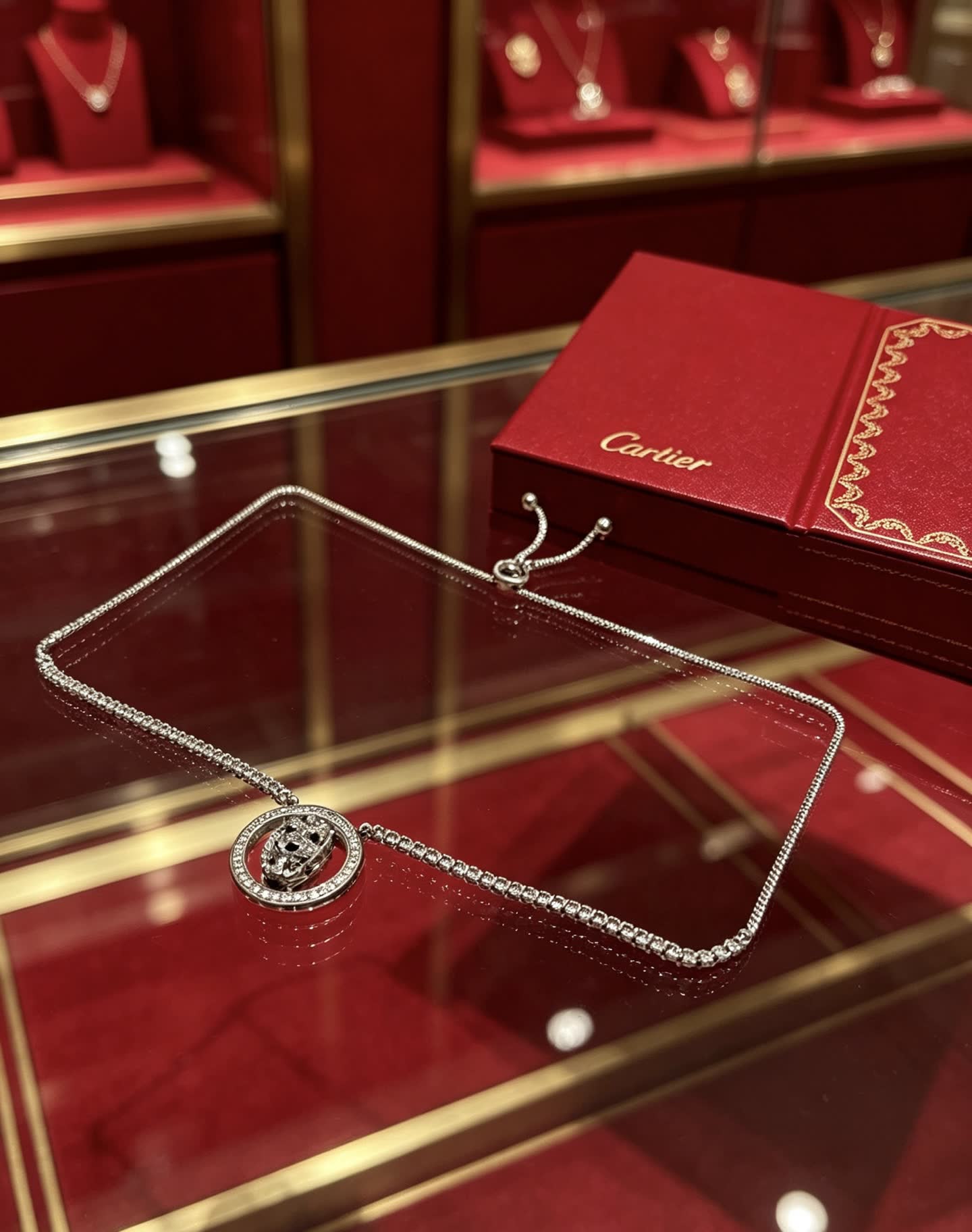 Cartier Silver Circle Pendant with Black Stones