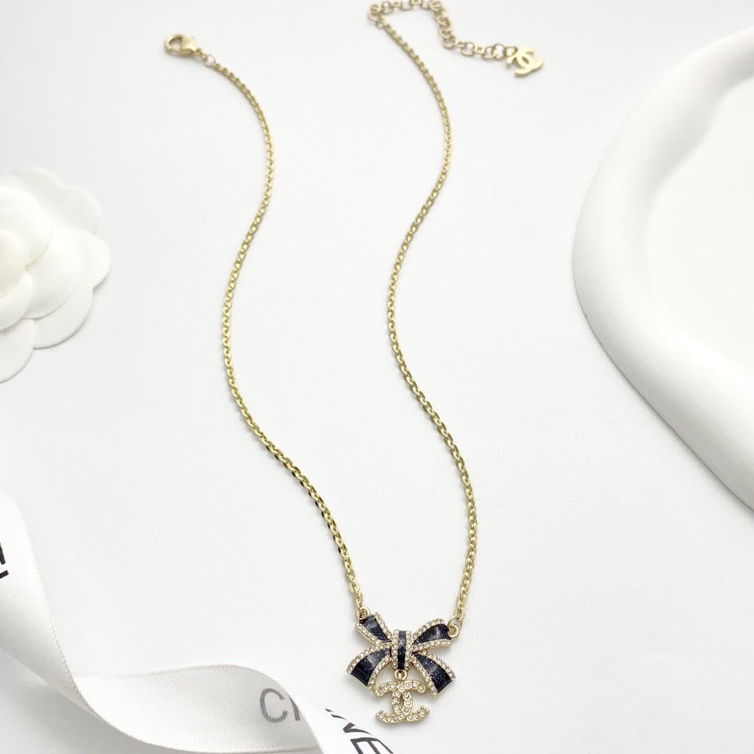 Chanel Gold Tone Black Bow Necklace