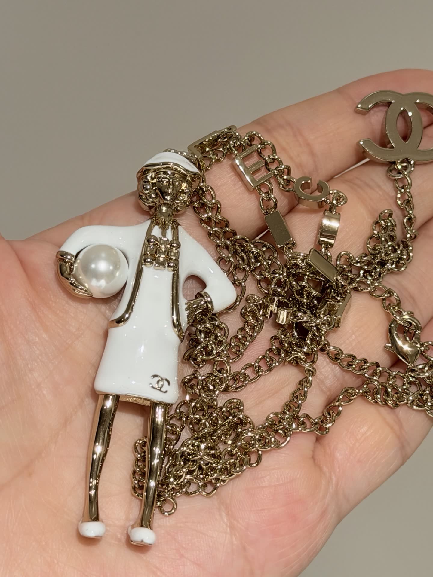 Chanel Gold Tone White Enamel Figurine Necklace