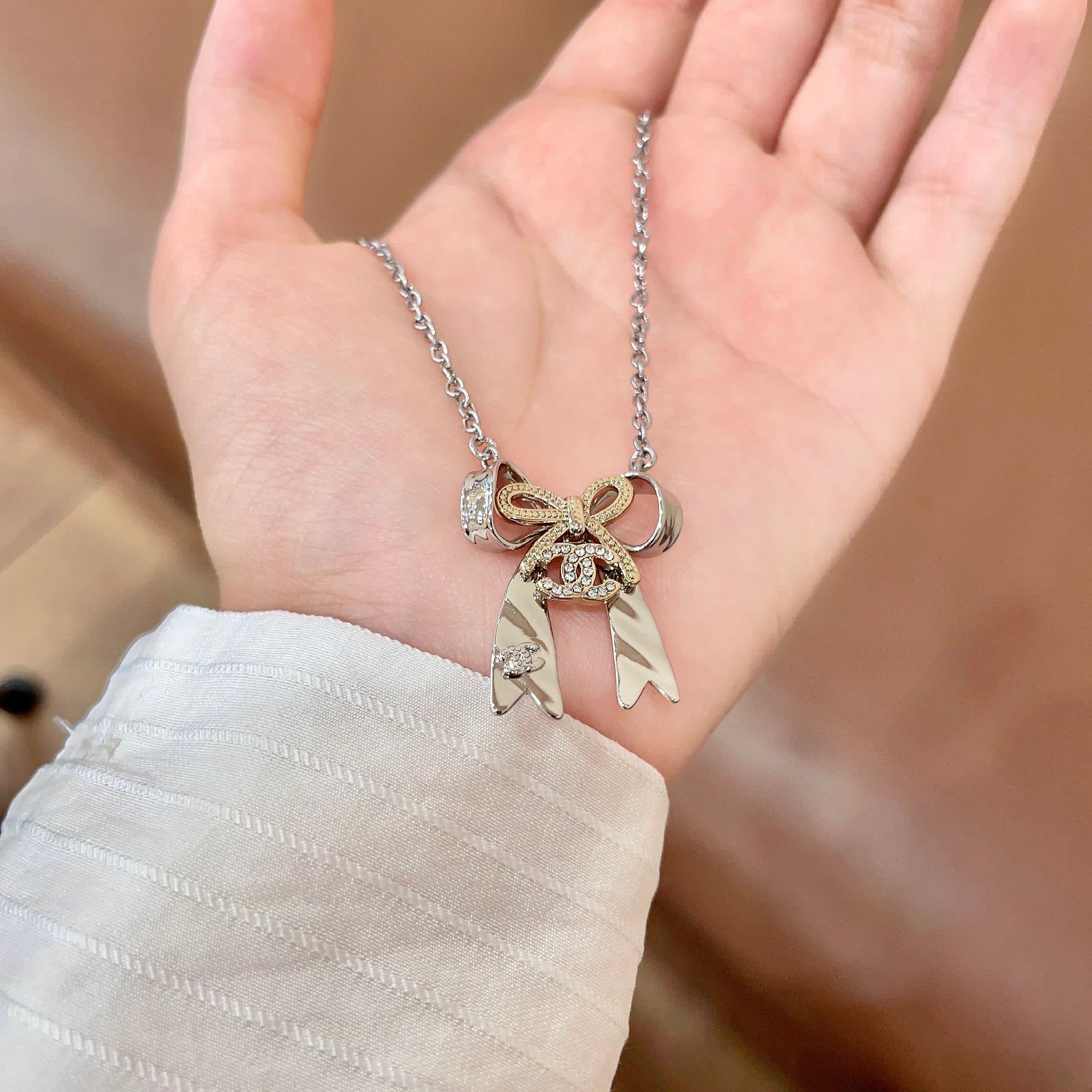 Chanel Silver Bow Tie Pendant Necklace