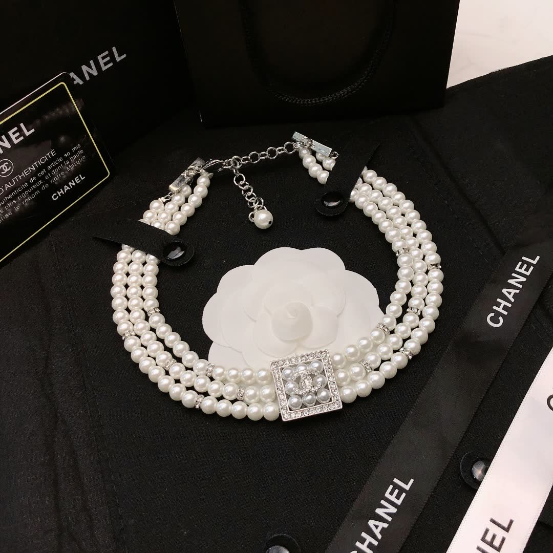 Chanel Elegant Triple Strand Pearl Necklace with Diamond Clasp