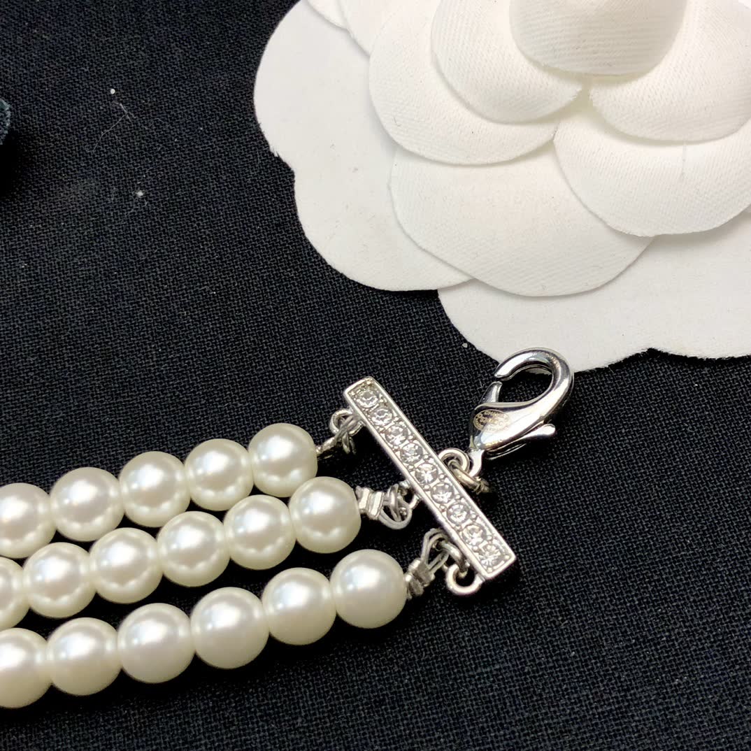 Chanel Elegant Triple Strand Pearl Necklace with Diamond Clasp