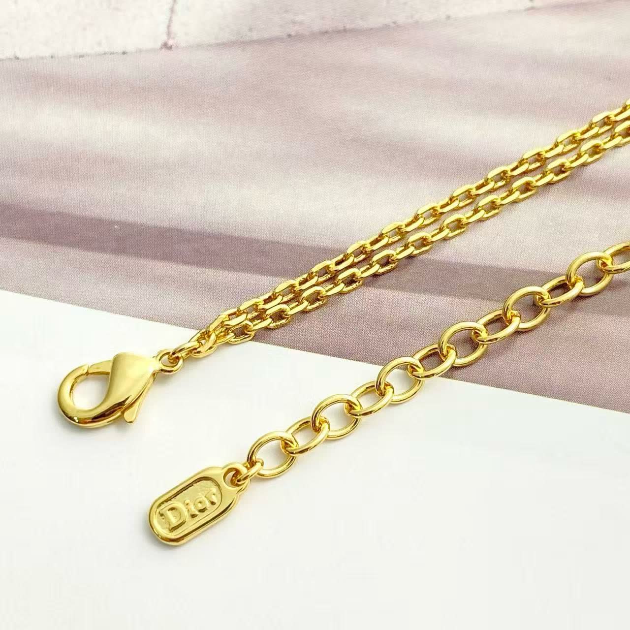 Dior Gold-Tone Necklace with Bow and Clover Charms