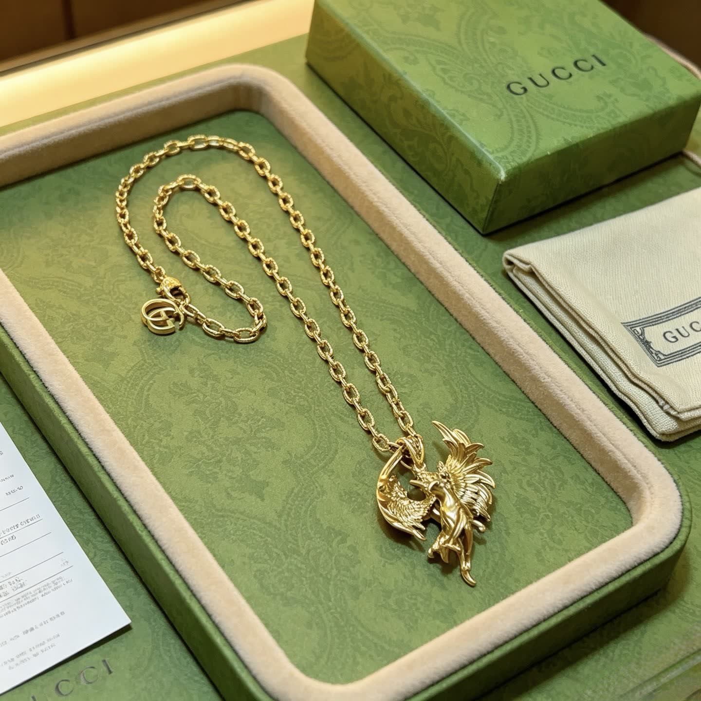 Gucci Gold Winged Figure Pendant Necklace