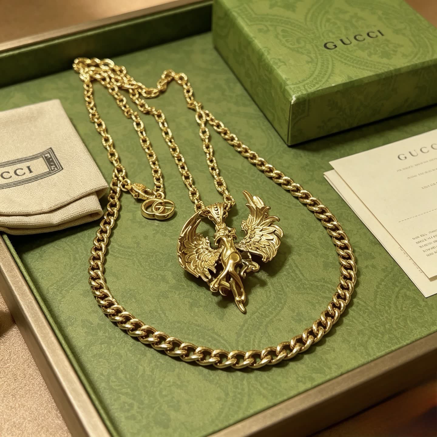 Gucci Gold Winged Figure Pendant Necklace