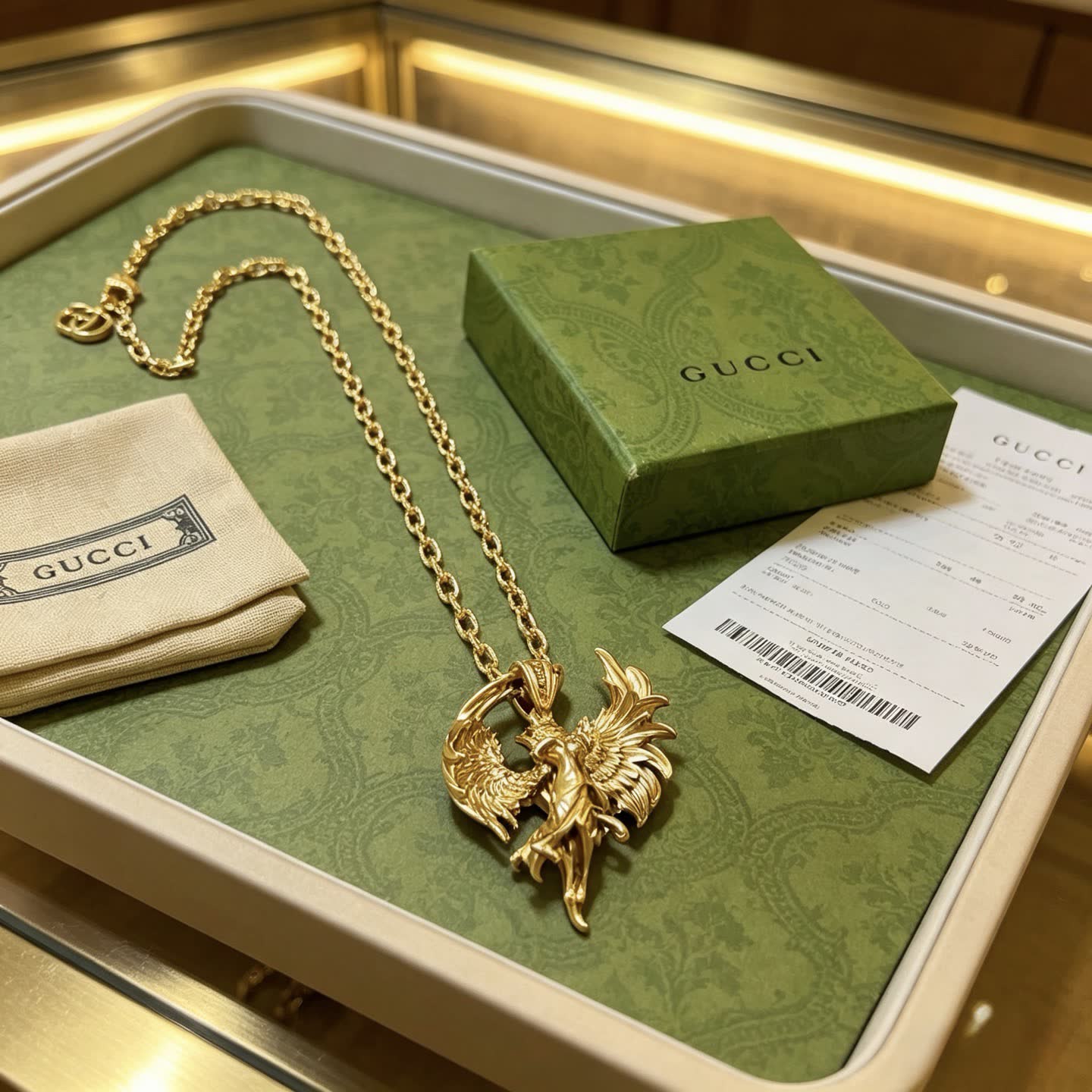 Gucci Gold Winged Figure Pendant Necklace