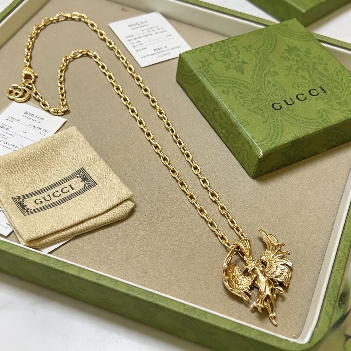 Gucci Gold Winged Figure Pendant Necklace