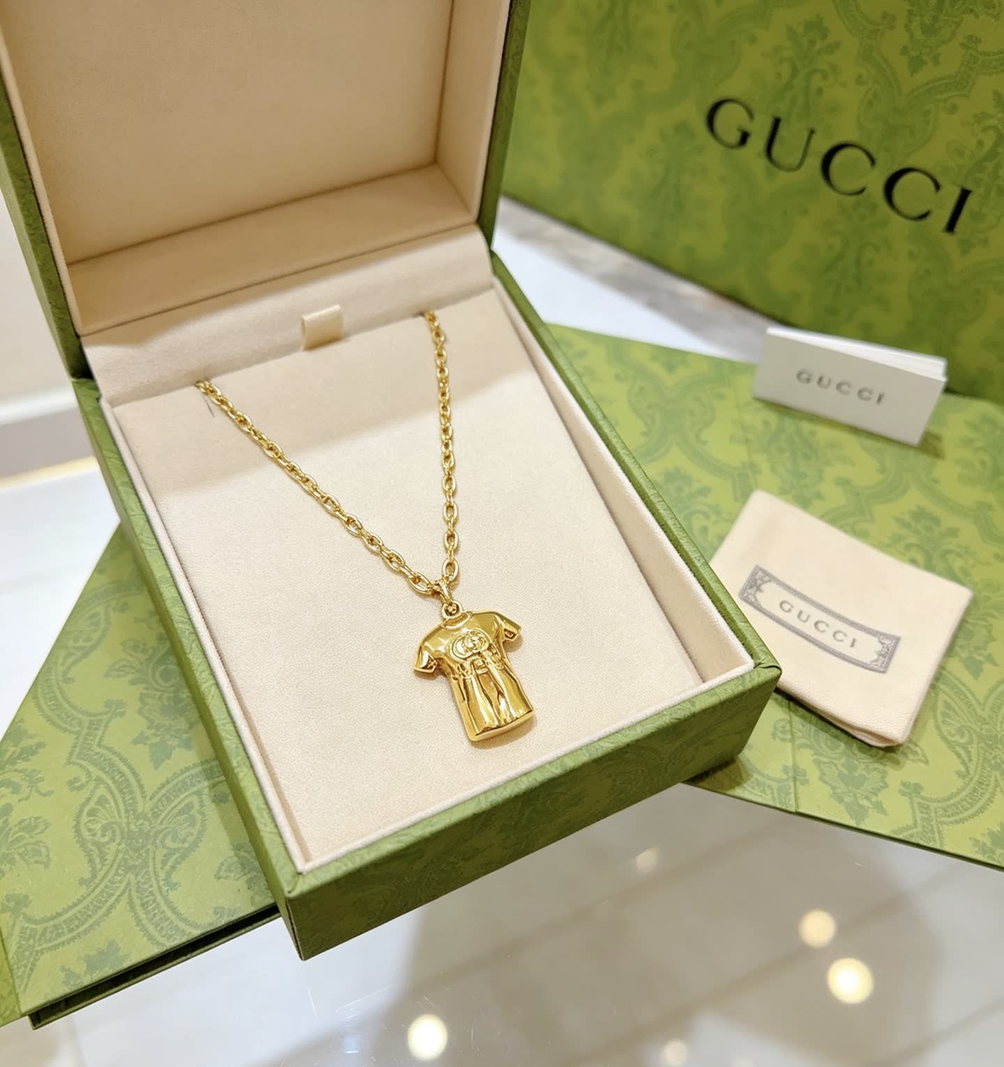 Gucci Gold Chain with T-shirt Pendant Gucci Gold Chain with T-shirt Pendant