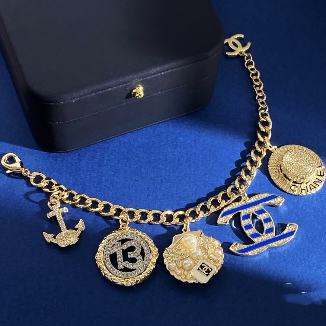 Chanel Gold Tone Charm Bracelet with Crystal and Pearl Accents