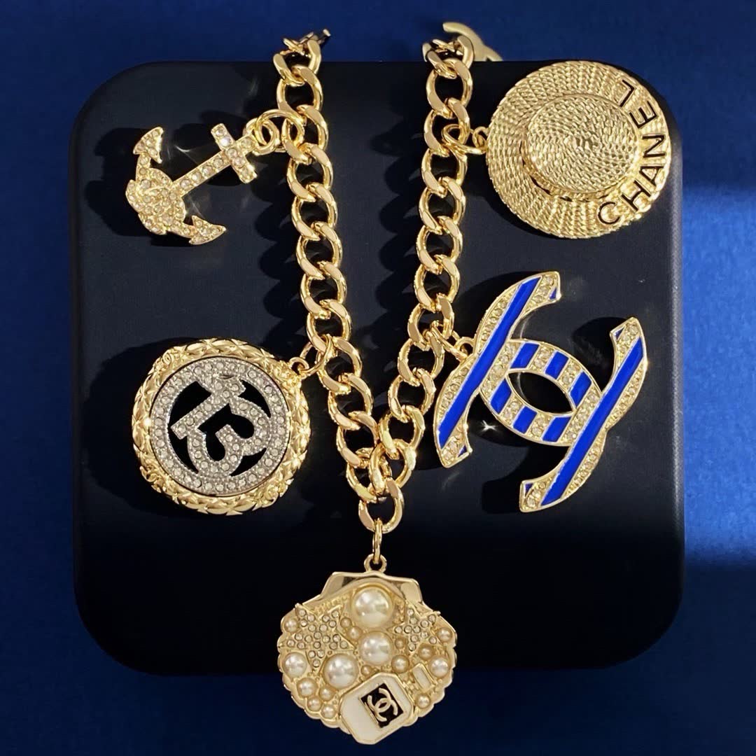 Chanel Gold Tone Charm Bracelet with Crystal and Pearl Accents