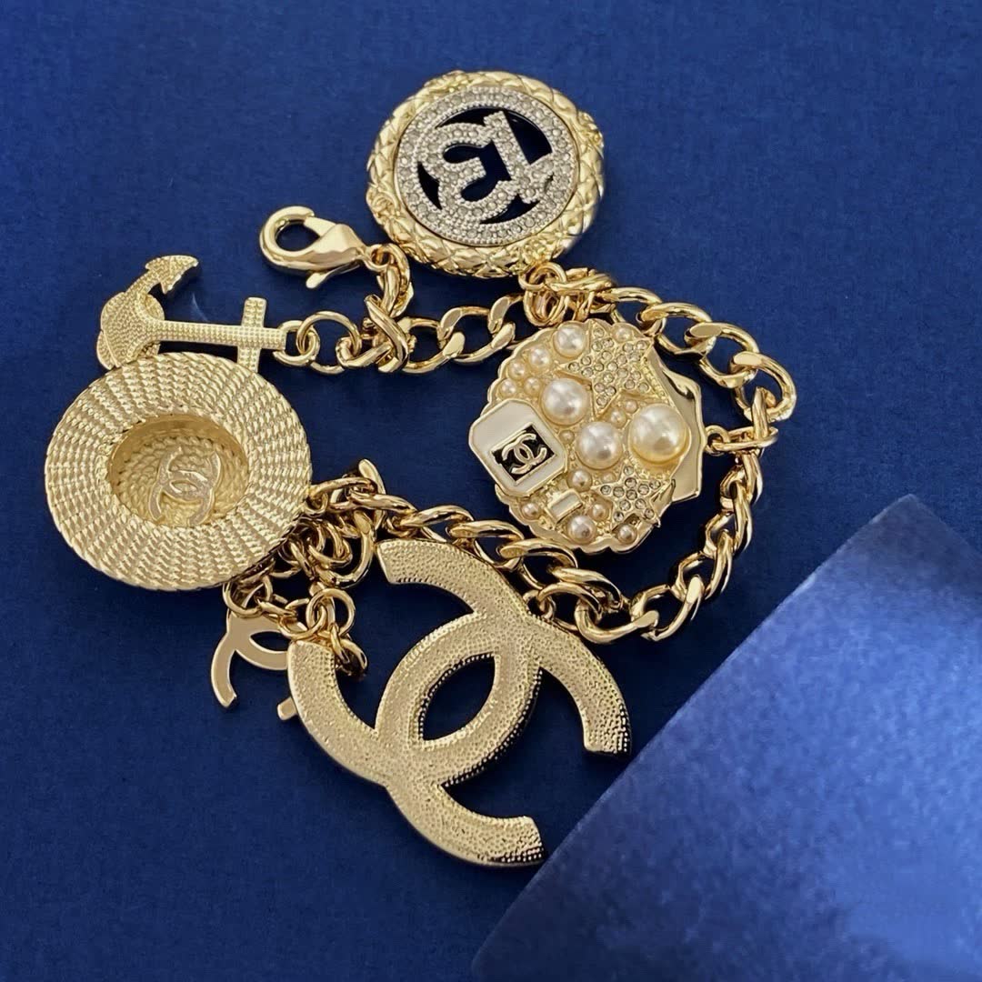 Chanel Gold Tone Charm Bracelet with Crystal and Pearl Accents