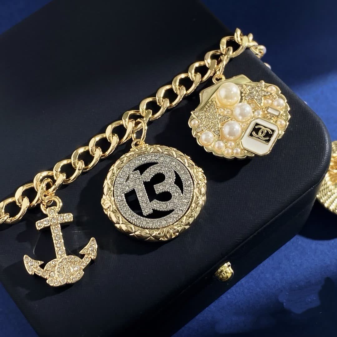 Chanel Gold Tone Charm Bracelet with Crystal and Pearl Accents