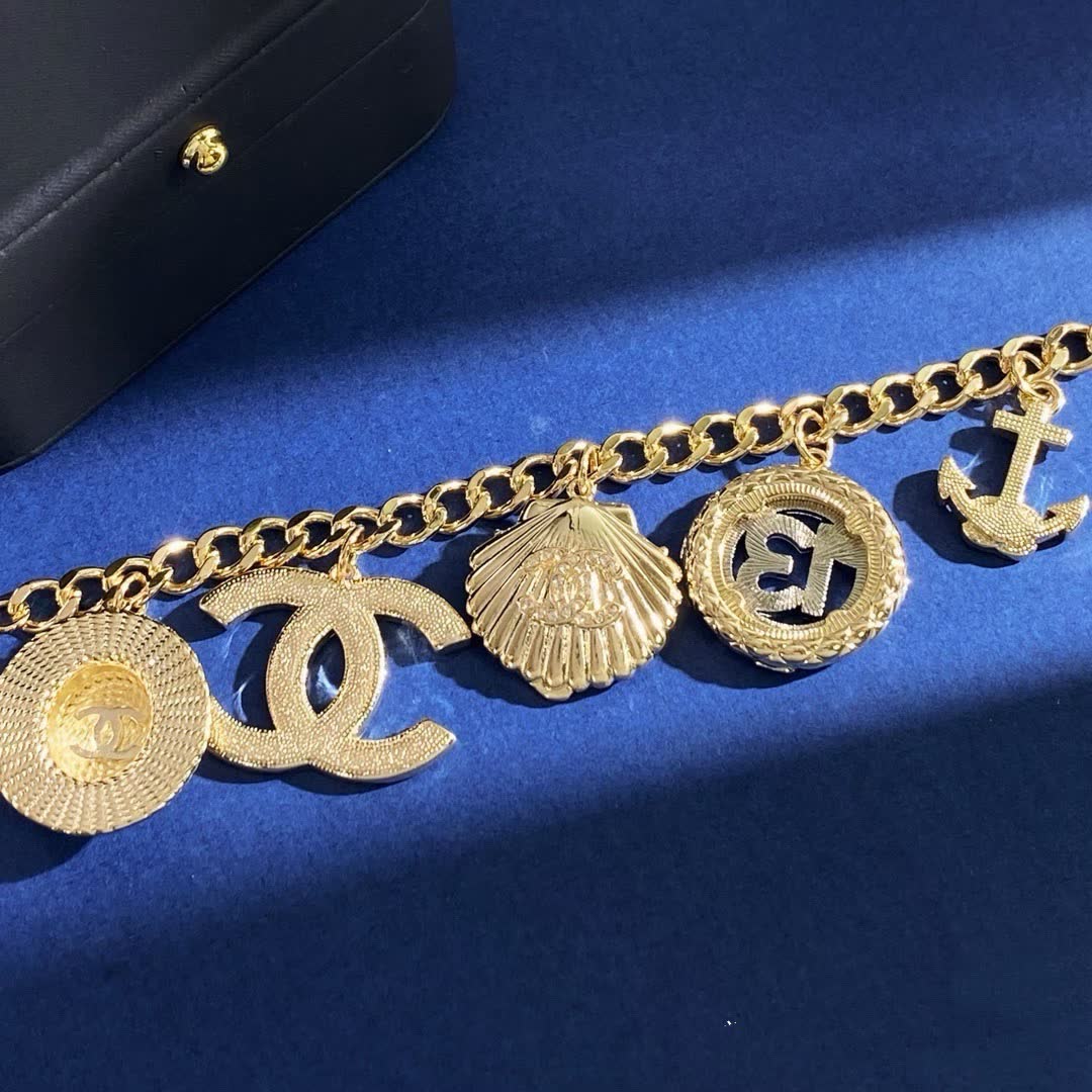 Chanel Gold Tone Charm Bracelet with Crystal and Pearl Accents