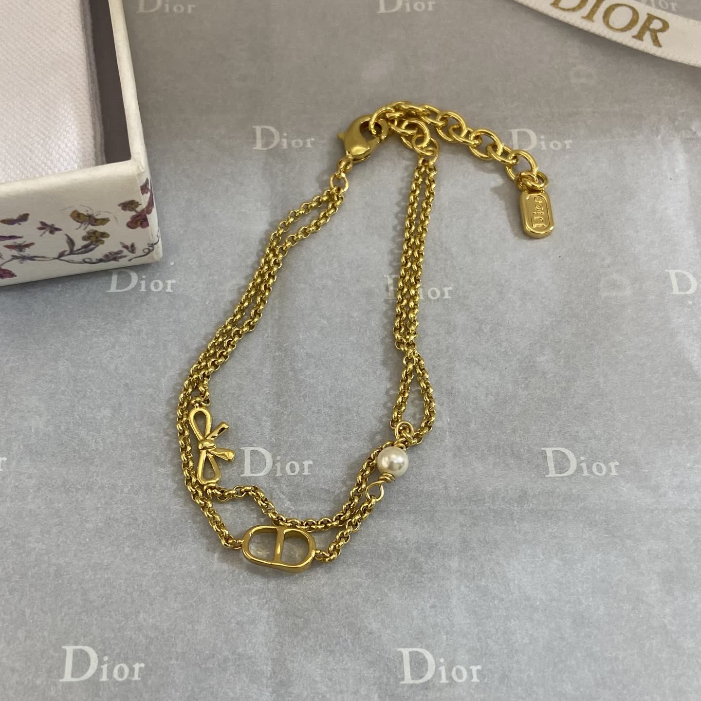 Dior Gold Tone Double Chain Bracelet with Pearl and Bow Dior Gold Tone Double Chain Bracelet with Pearl and Bow