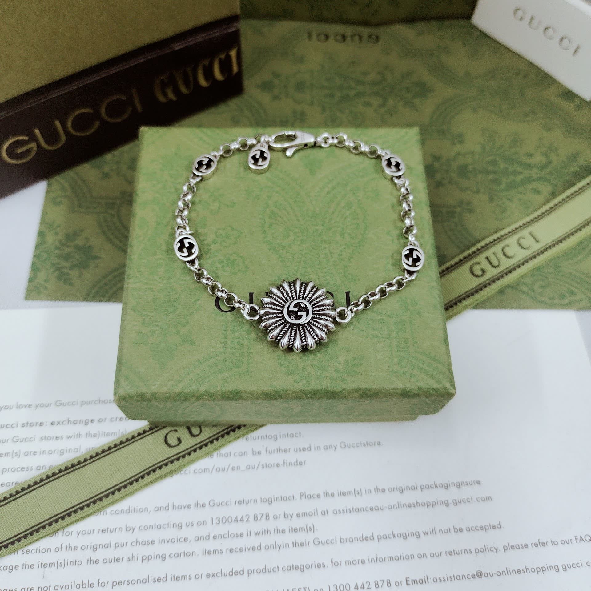 Gucci Silver Bracelet with Flower and Logo Charms