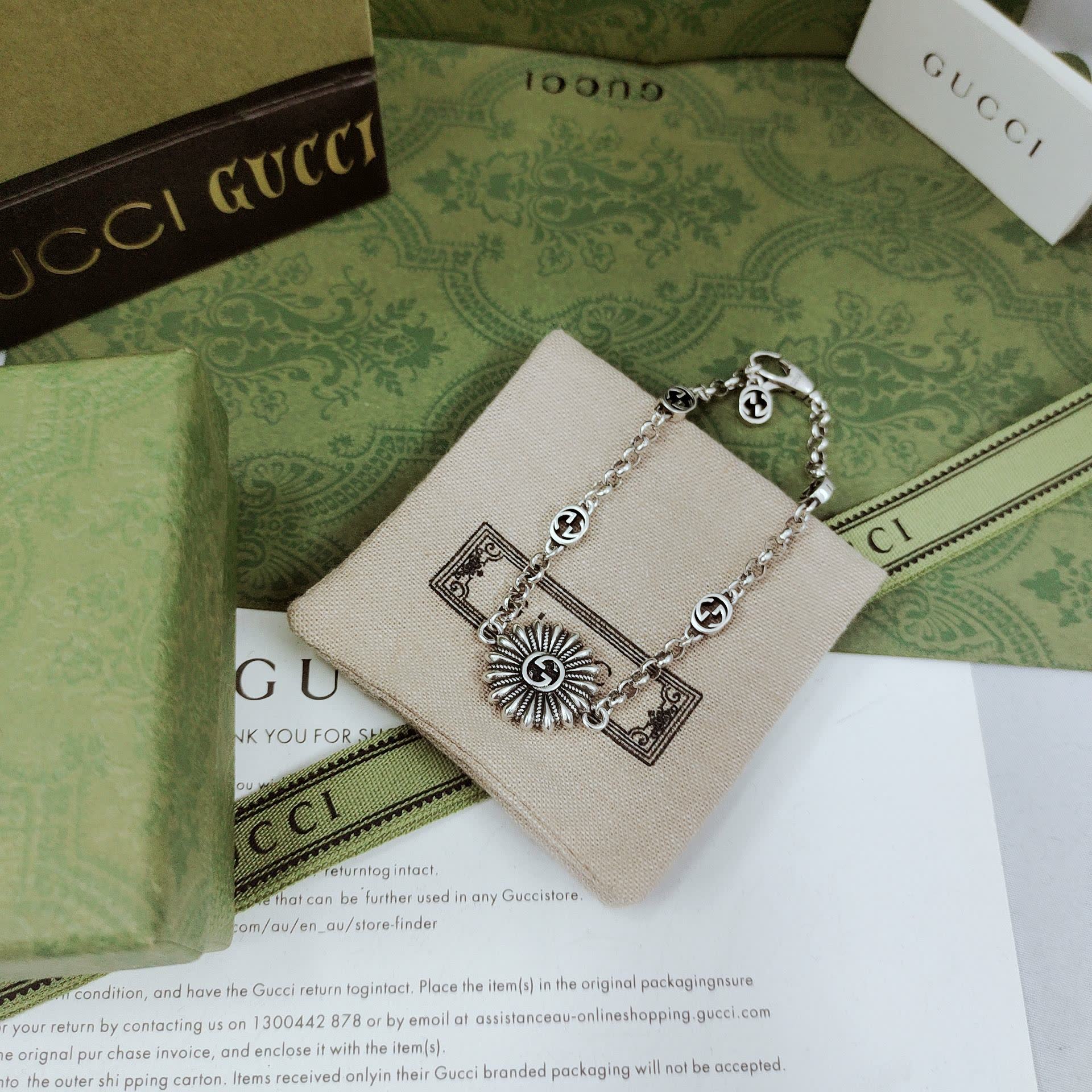 Gucci Silver Bracelet with Flower and Logo Charms