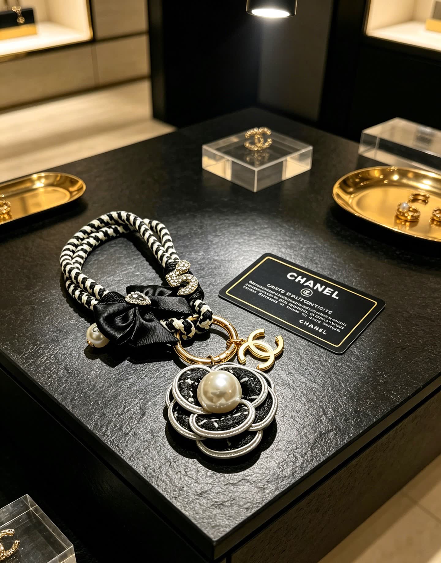 Chanel Black and White Braided Keychain with Pearl Flower Charm Chanel Black and White Braided Keychain with Pearl Flower Charm