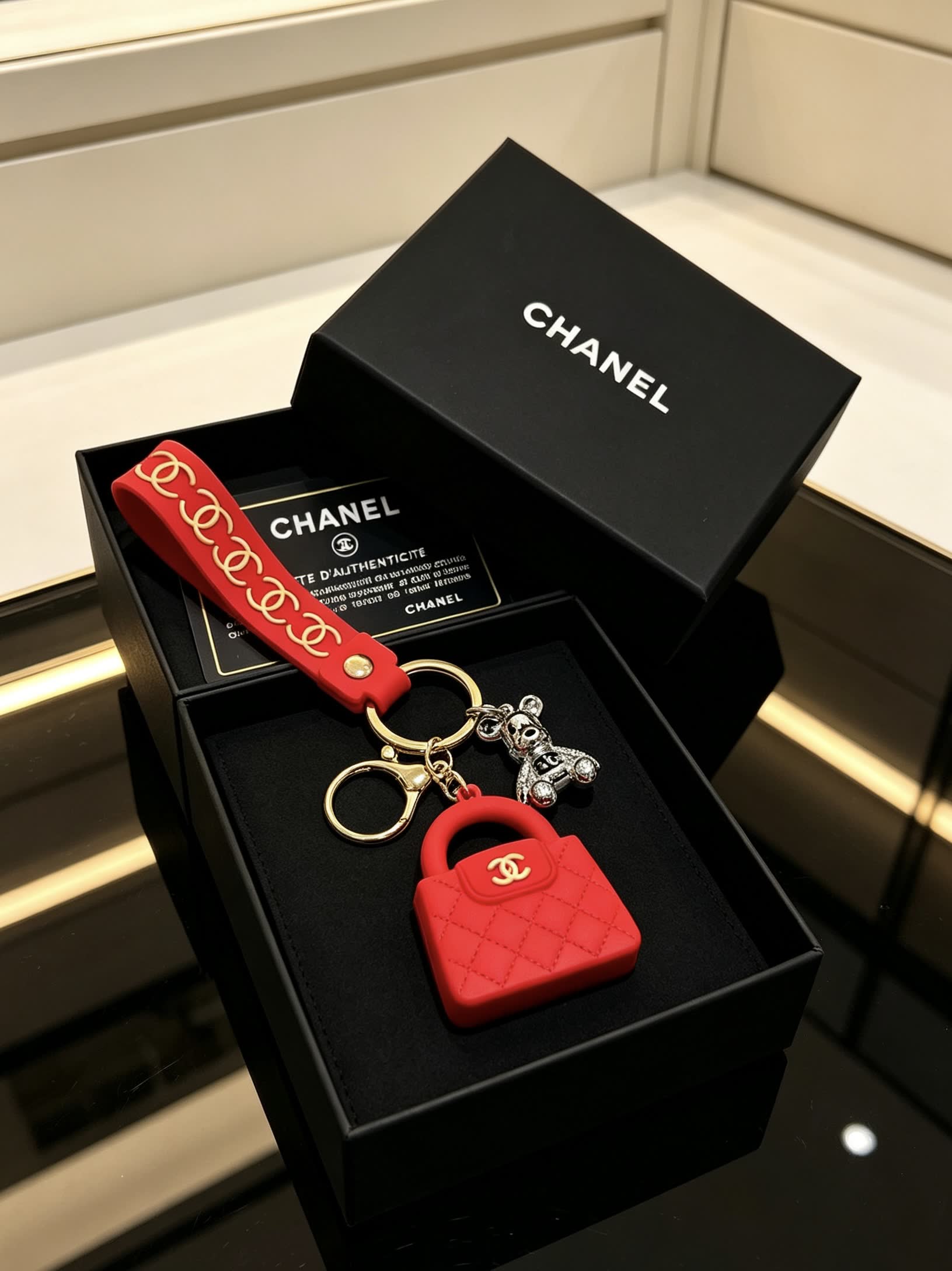 Chanel Red Rubber Keychain with Gold Chain Strap and Silver Bear Charm