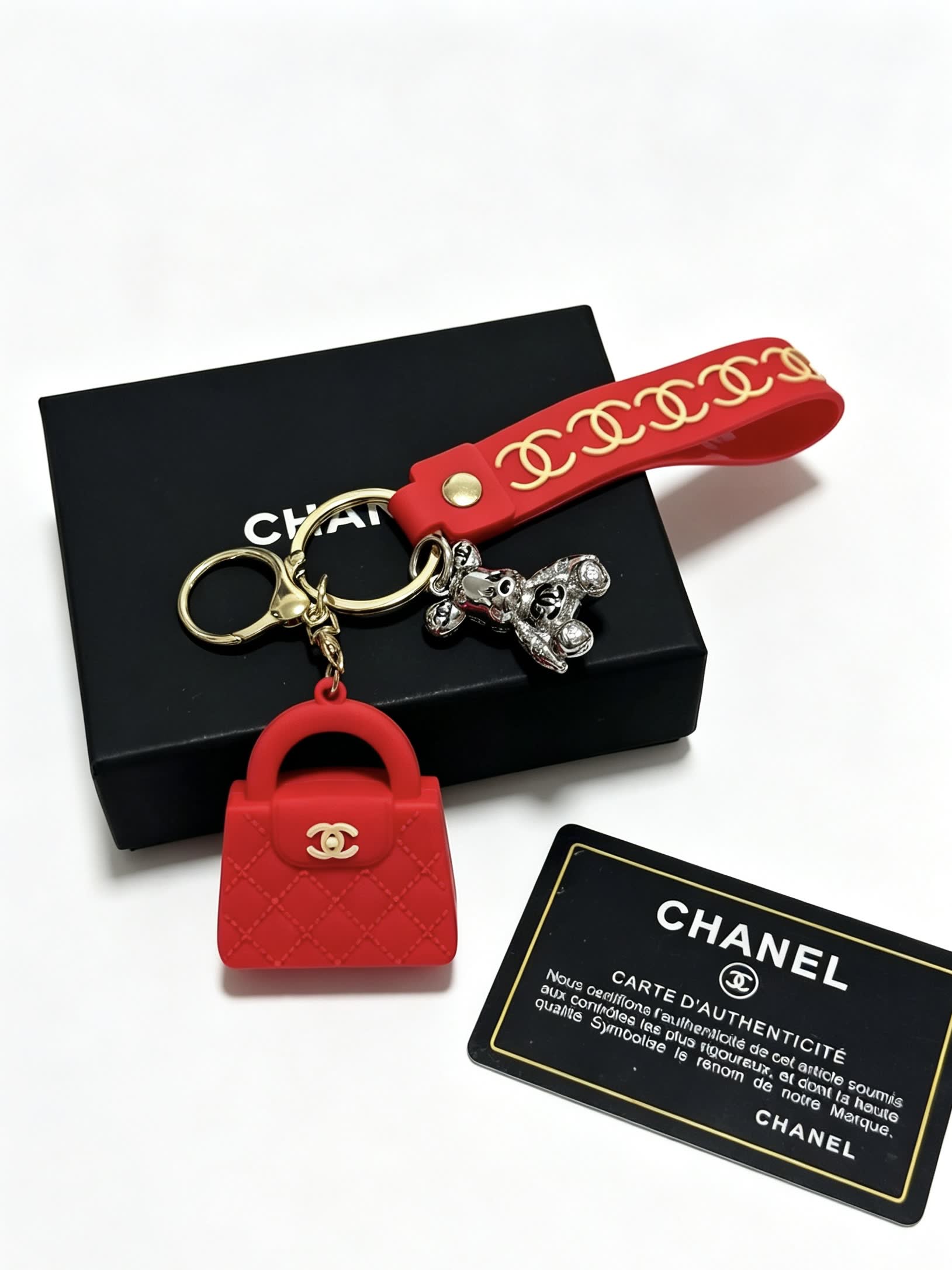 Chanel Red Rubber Keychain with Gold Chain Strap and Silver Bear Charm