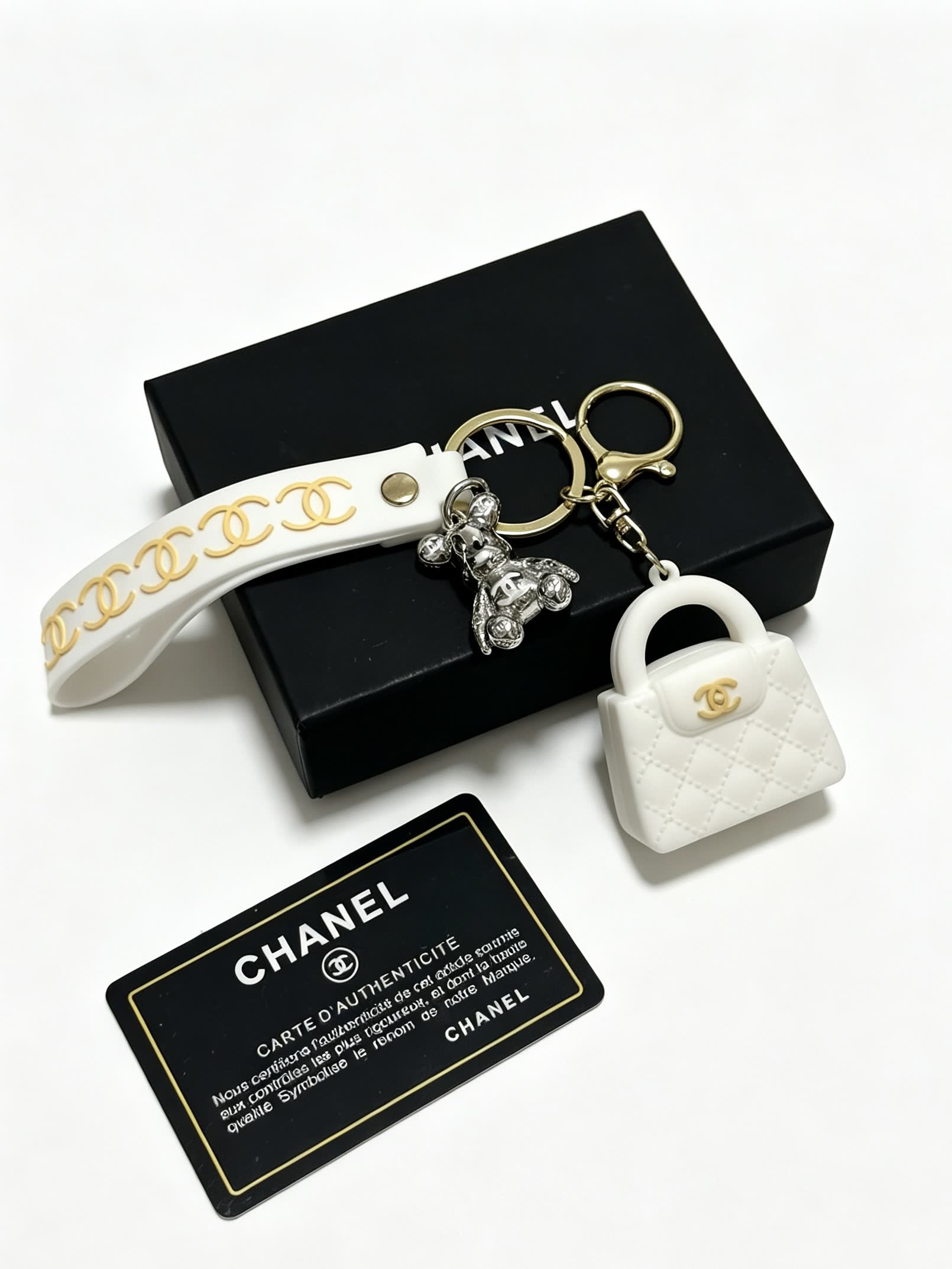 Chanel White Leather Keychain with Gold Chain Strap and Silver Bear Charm