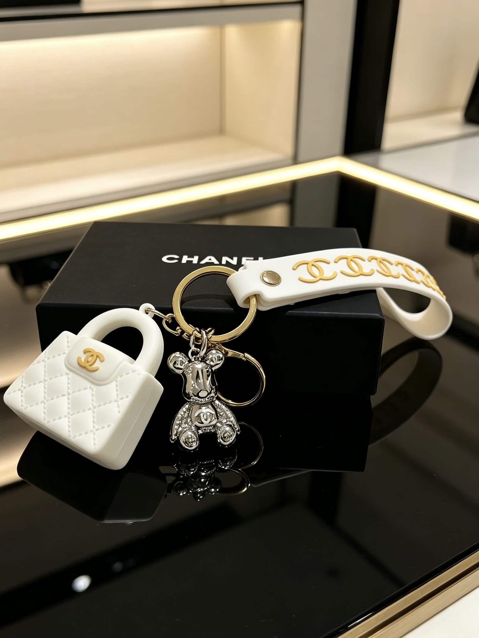 Chanel White Leather Keychain with Gold Chain Strap and Silver Bear Charm