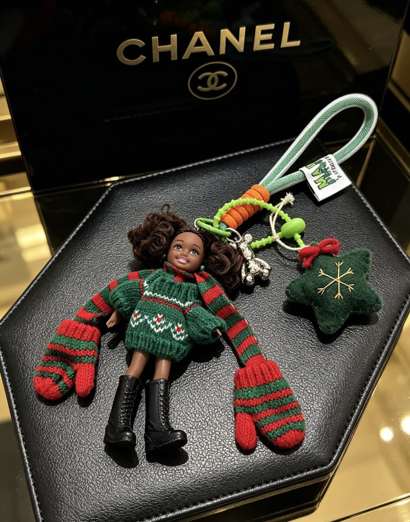 Chanel Christmas-themed keychain with doll and festive accessories