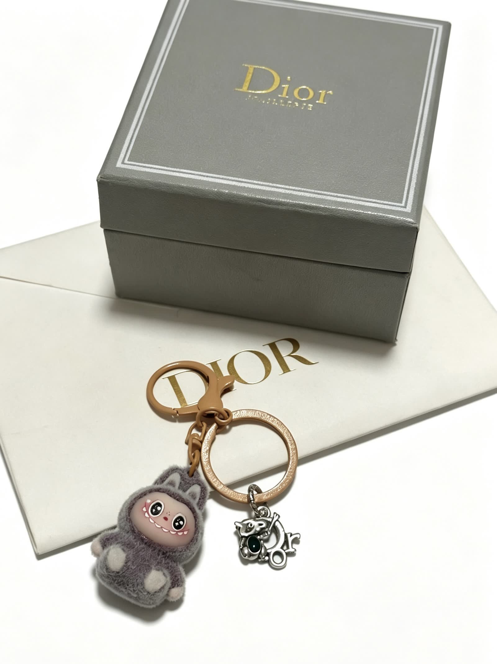 Dior Grey Furry Keychain with Silver Charm