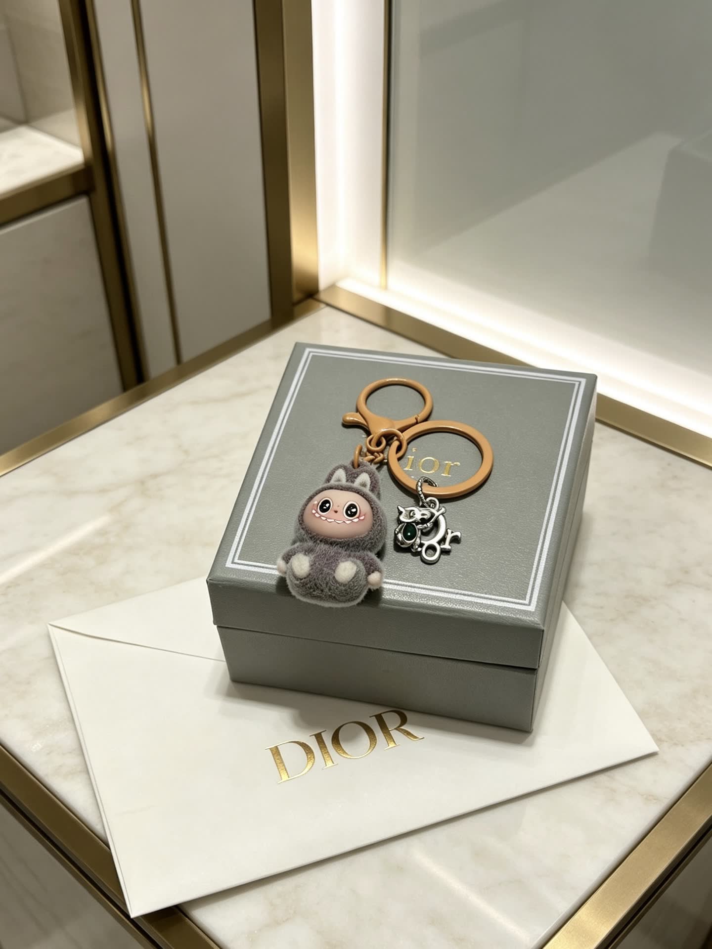 Dior Grey Furry Keychain with Silver Charm