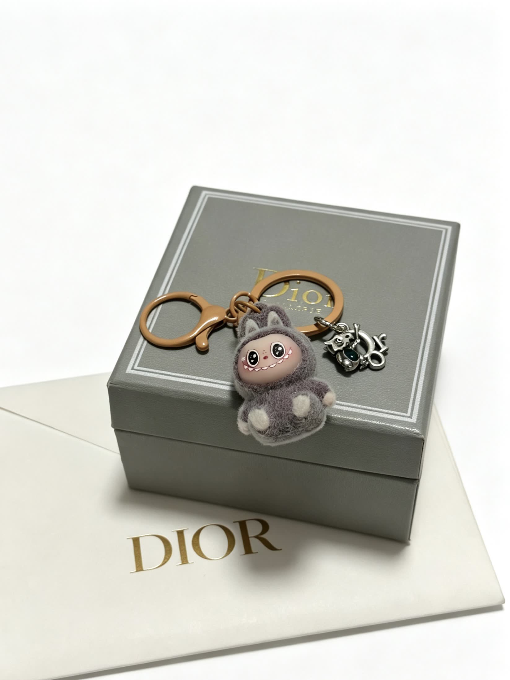 Dior Grey Furry Keychain with Silver Charm