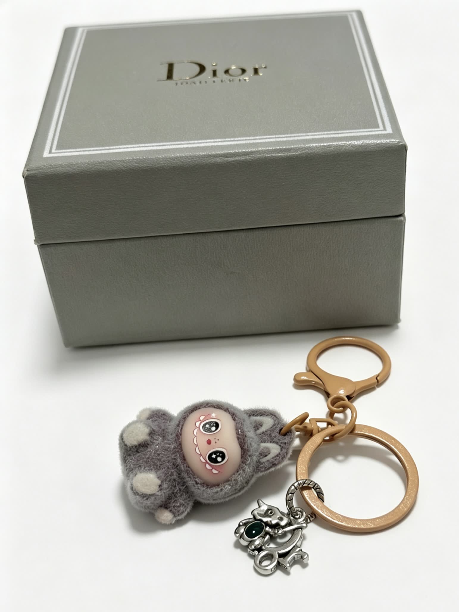 Dior Grey Furry Keychain with Silver Charm