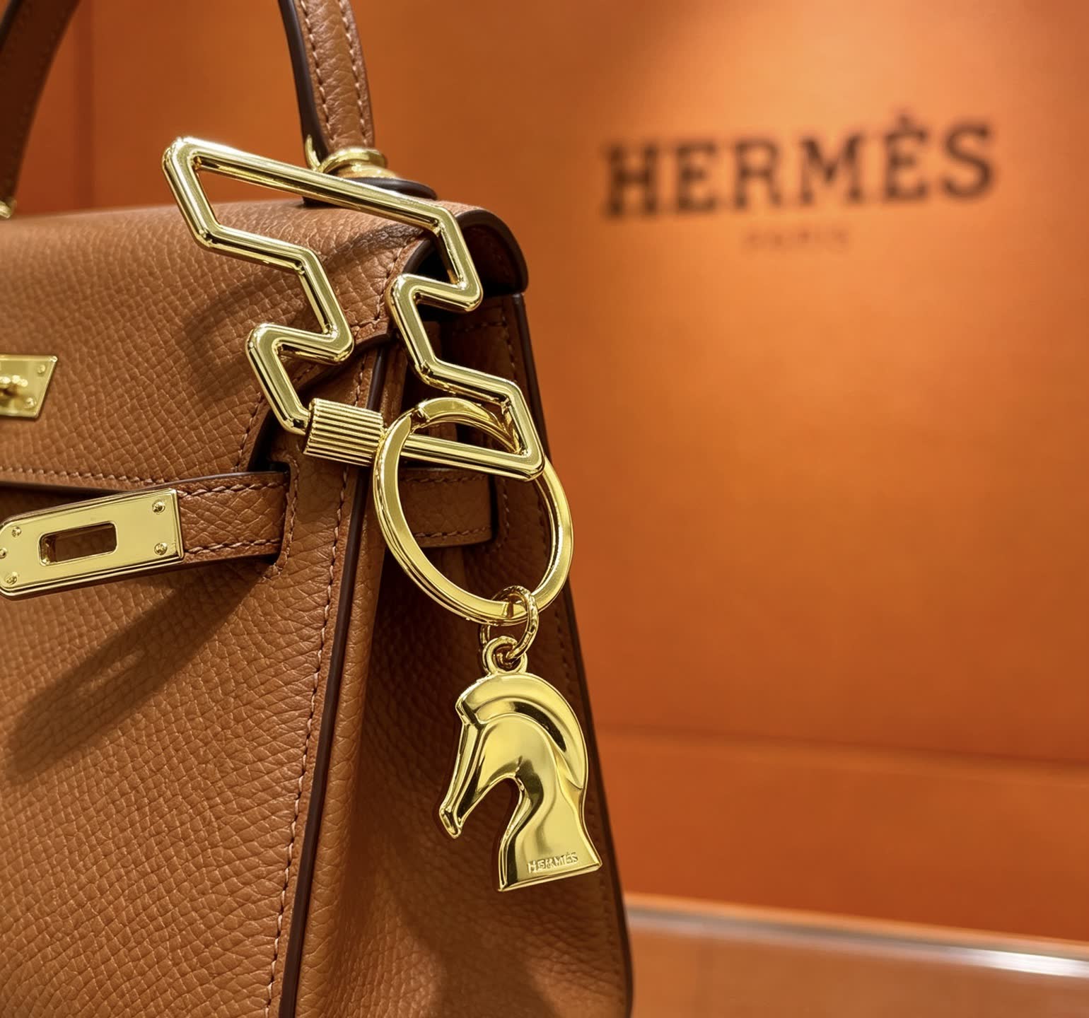 Hermès Gold-Tone Leather Keychain with Horse Head Charm Hermès Gold-Tone Leather Keychain with Horse Head Charm